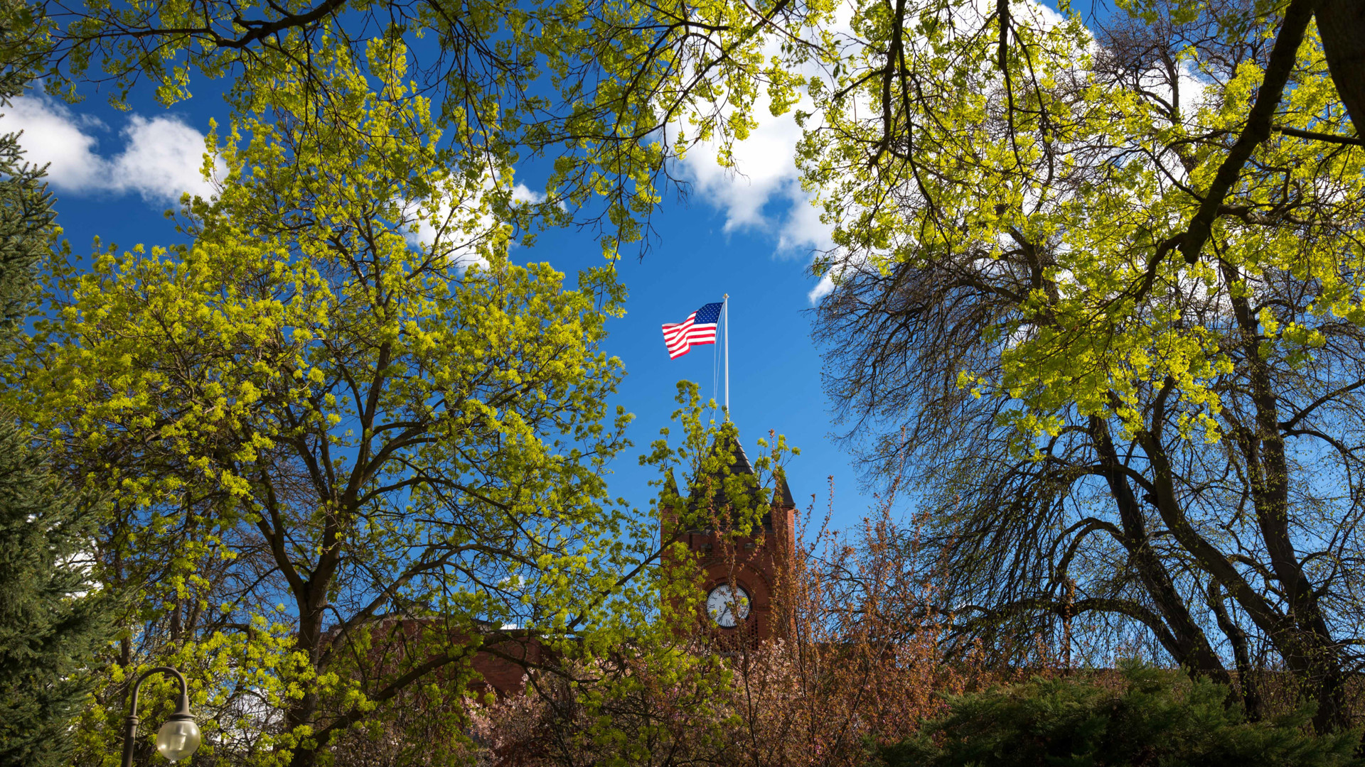 US flag at top of Reid Centennial Hall clock tower
